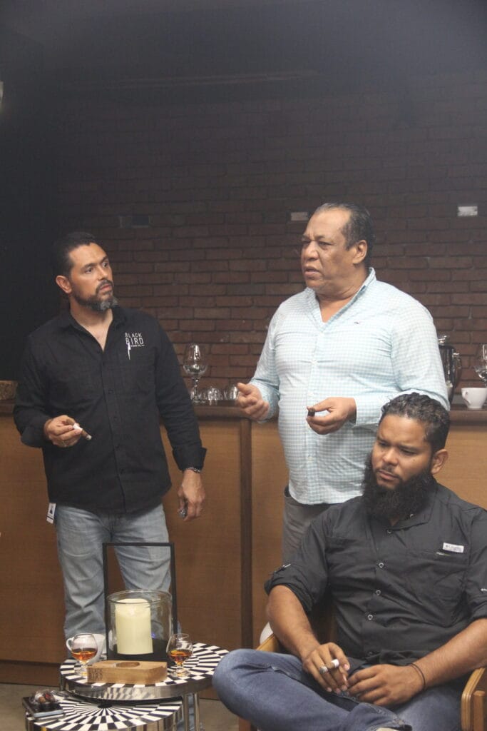 Participants smoking filler, binder, and full blend during Crow component tasting at Blackbird factory