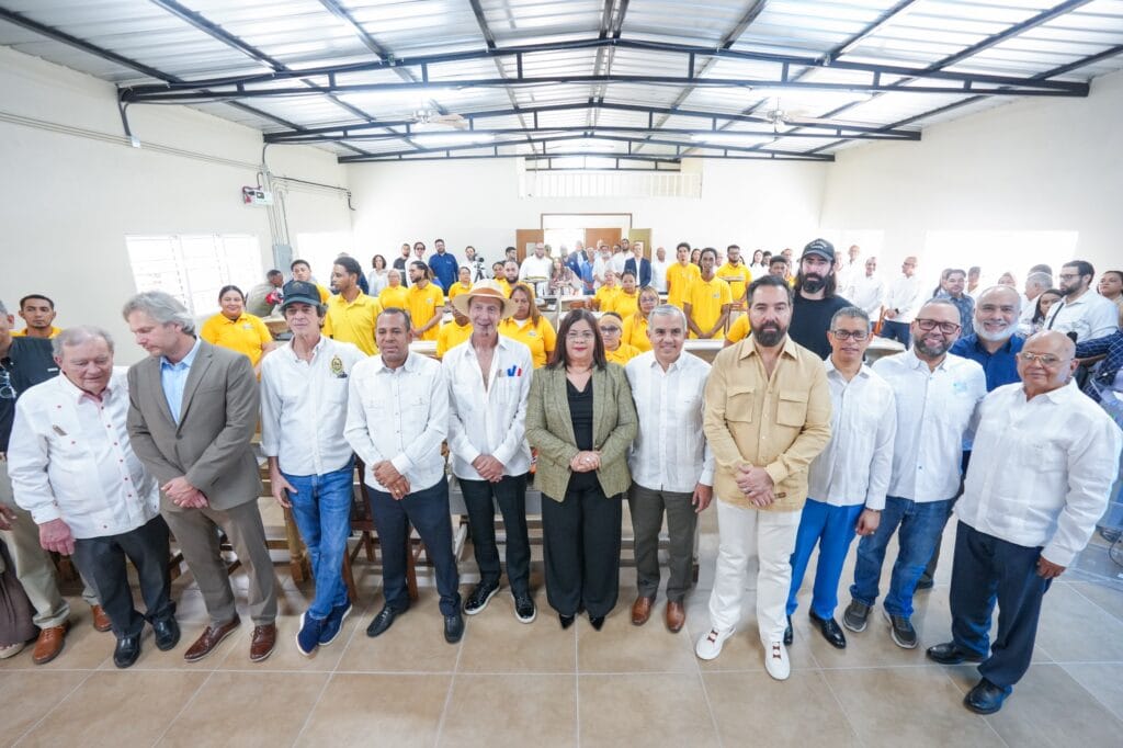 Group of local authorities, leaders, and community members gathered in a hall during an official meeting.